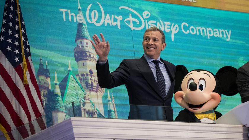 Chief executive officer and chairman of The Walt Disney Company Bob Iger and Mickey Mouse look on before ringing the opening bell at the New York Stock Exchange (NYSE), November 27, 2017 in New York City. Disney is marking the company&#039;s 60th anniversary as a listed company on the NYSE.