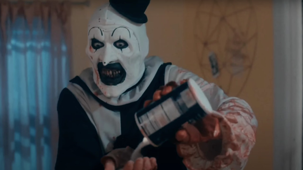 David Howard Thornton como Art the Clown echándose sal en la mano en Terrifier 2