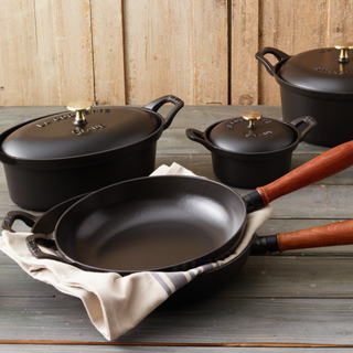 Set of black saucepans and frying pans