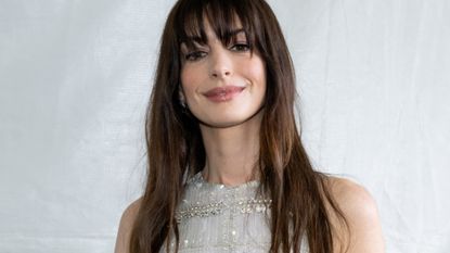 Anne Hathaway with bangs and closed-mouth smile