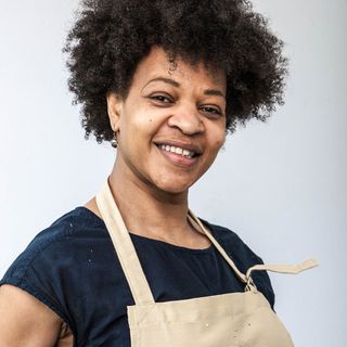 bake off contestant with blue top and apron