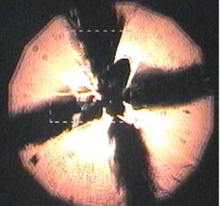 An optical micrograph shows lanthanum superhydride heated by a laser under extreme pressures.