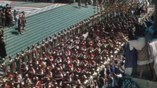 Roman soldiers marching in front of a cheering crowd in Quo Vadis