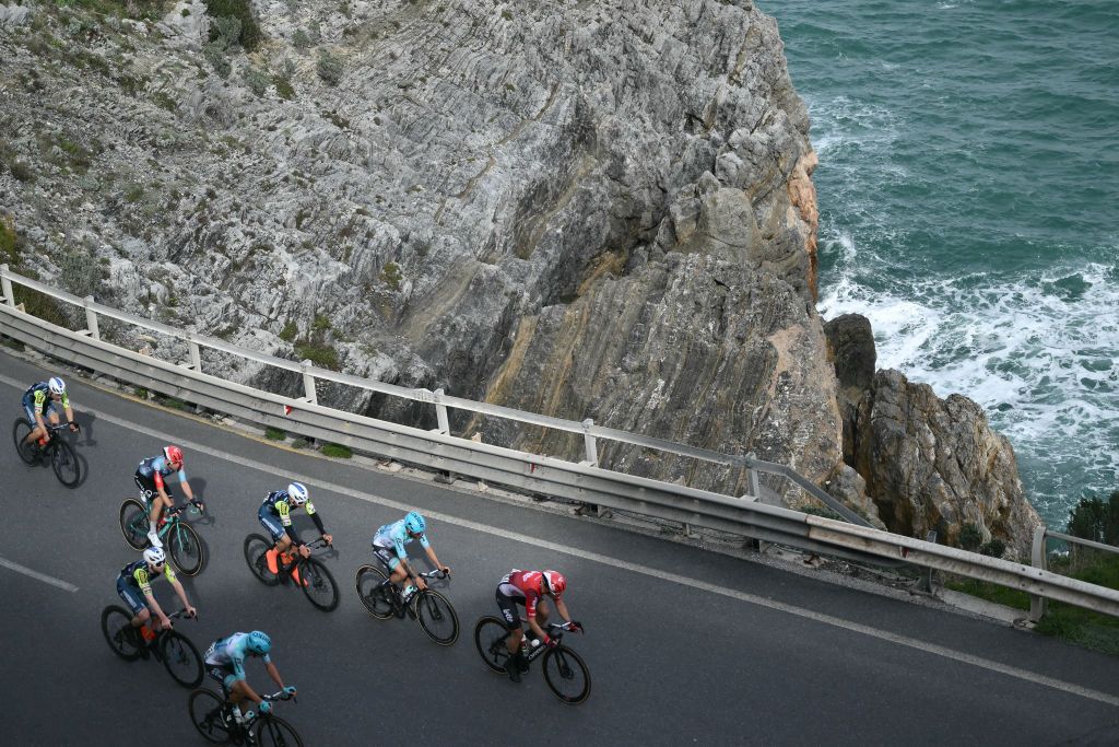 The group at the head of the race rides along Noli's cape during the Milan - Sanremo one-day classic cycling race, on March 22, 2025. (Photo by Marco BERTORELLO / AFP)
