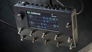 A Neural DSP Quad Cortex multi-effects pedal floating with a guitar cable