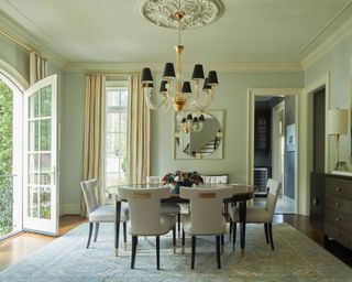 Elegant dining room opening up to garden, with decorative ceiling molding