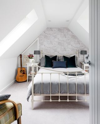 A white bedroom in a converted loft with a white and grey colour scheme