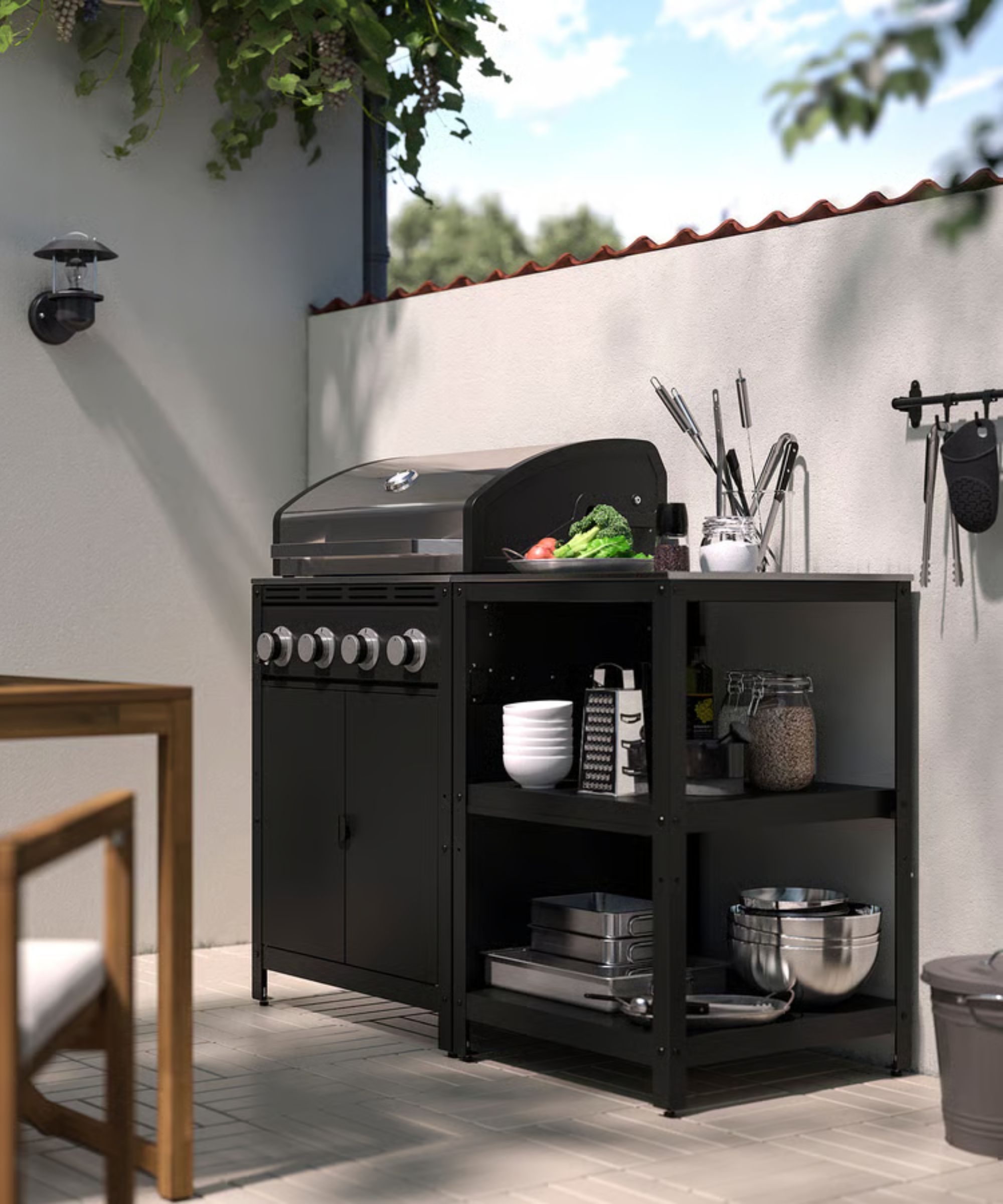 An outdoor kitchen with shelves and a grill