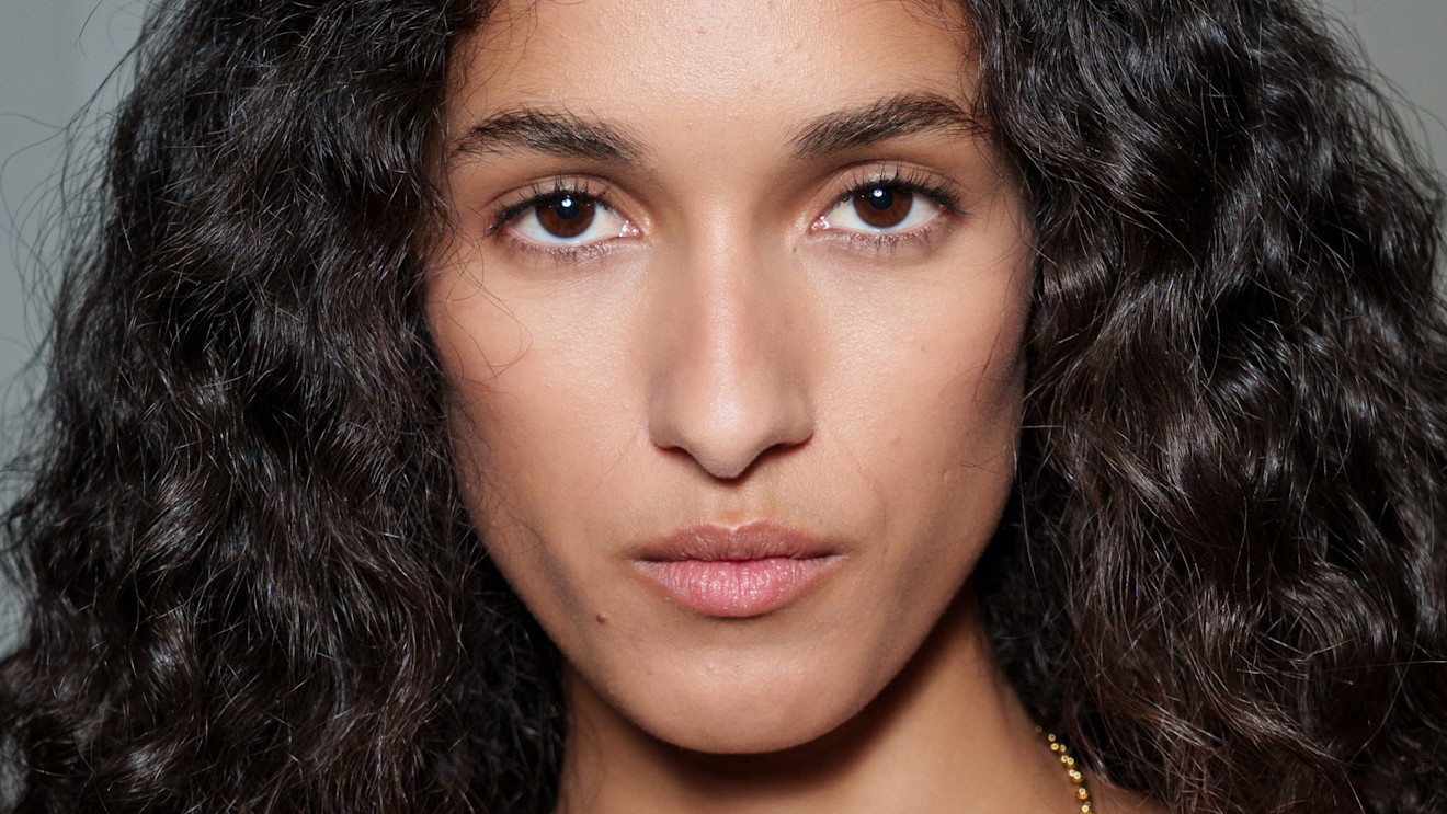 A model with glowing skin after using toner.