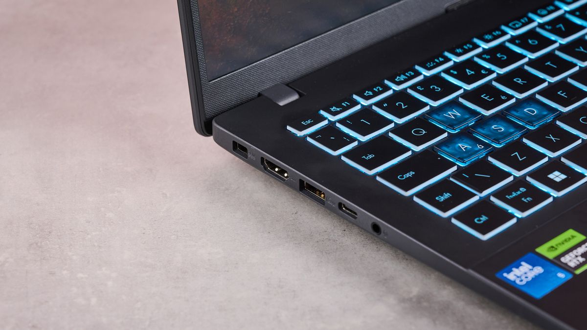 Close-up of left-side ports on Asus V16, on a desk
