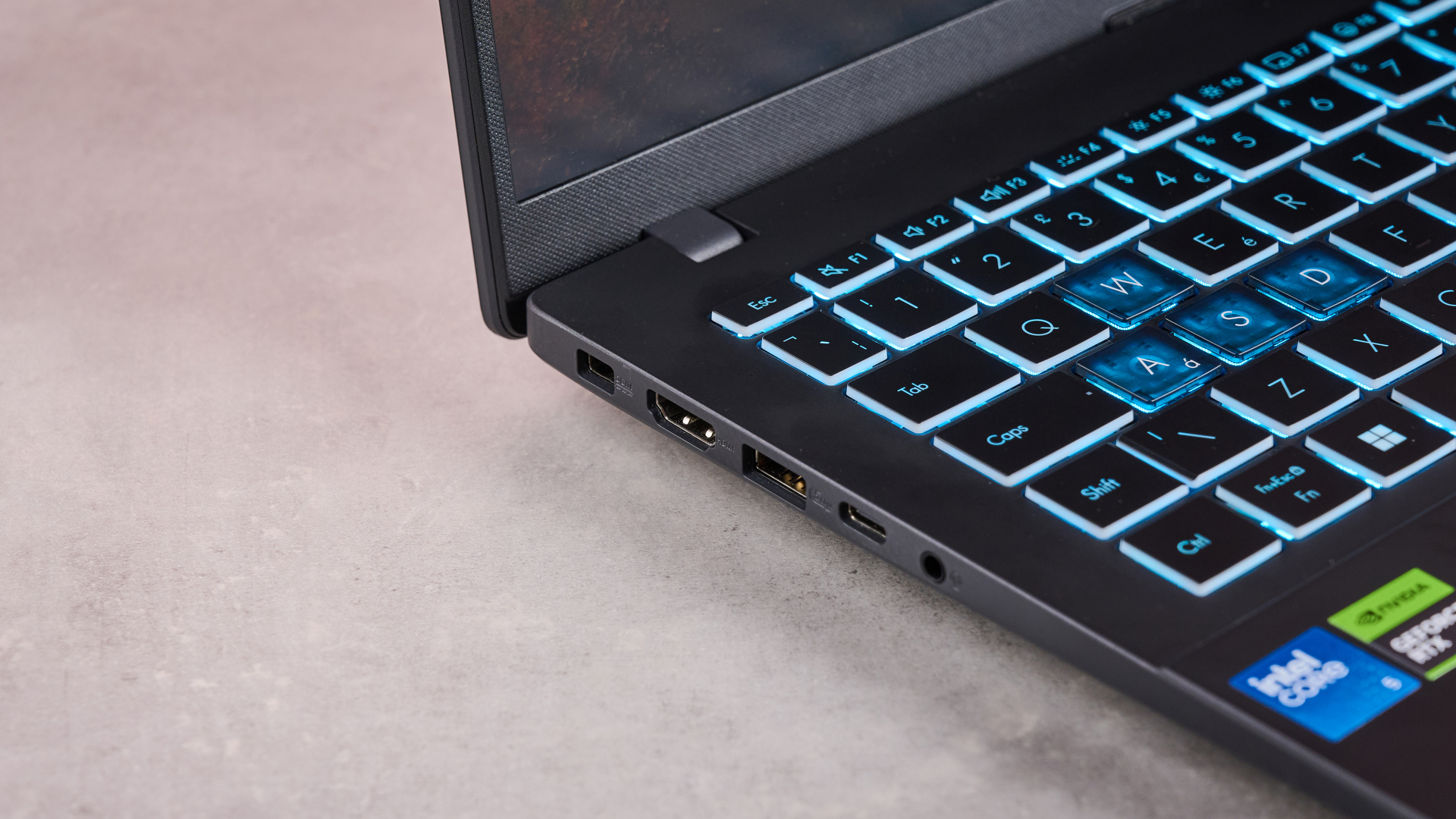 Close-up of left-side ports on Asus V16, on a desk