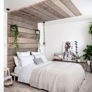 White bedroom with double bed and wooden headboard