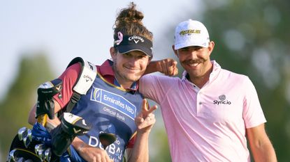 Erik van Rooyen of South Africa poses with his Caddie Alex Gaugert during day three of the Slync.io Dubai Desert Classic at Emirates Golf Club on January 29, 2022