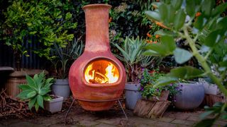 picture of clay chiminea with a fire on