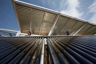 Brianna Bacon, right, and Lizzie DeLeonibus, left, of Maryland look out over Florida International University's solar thermal collector system at West Potomac Park in Washington, D.C., Sept. 28, 2011.