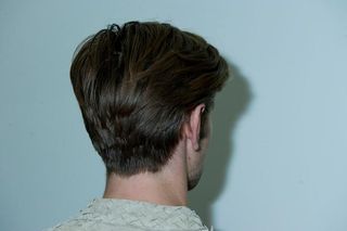 Photo of a back of a head of a male model