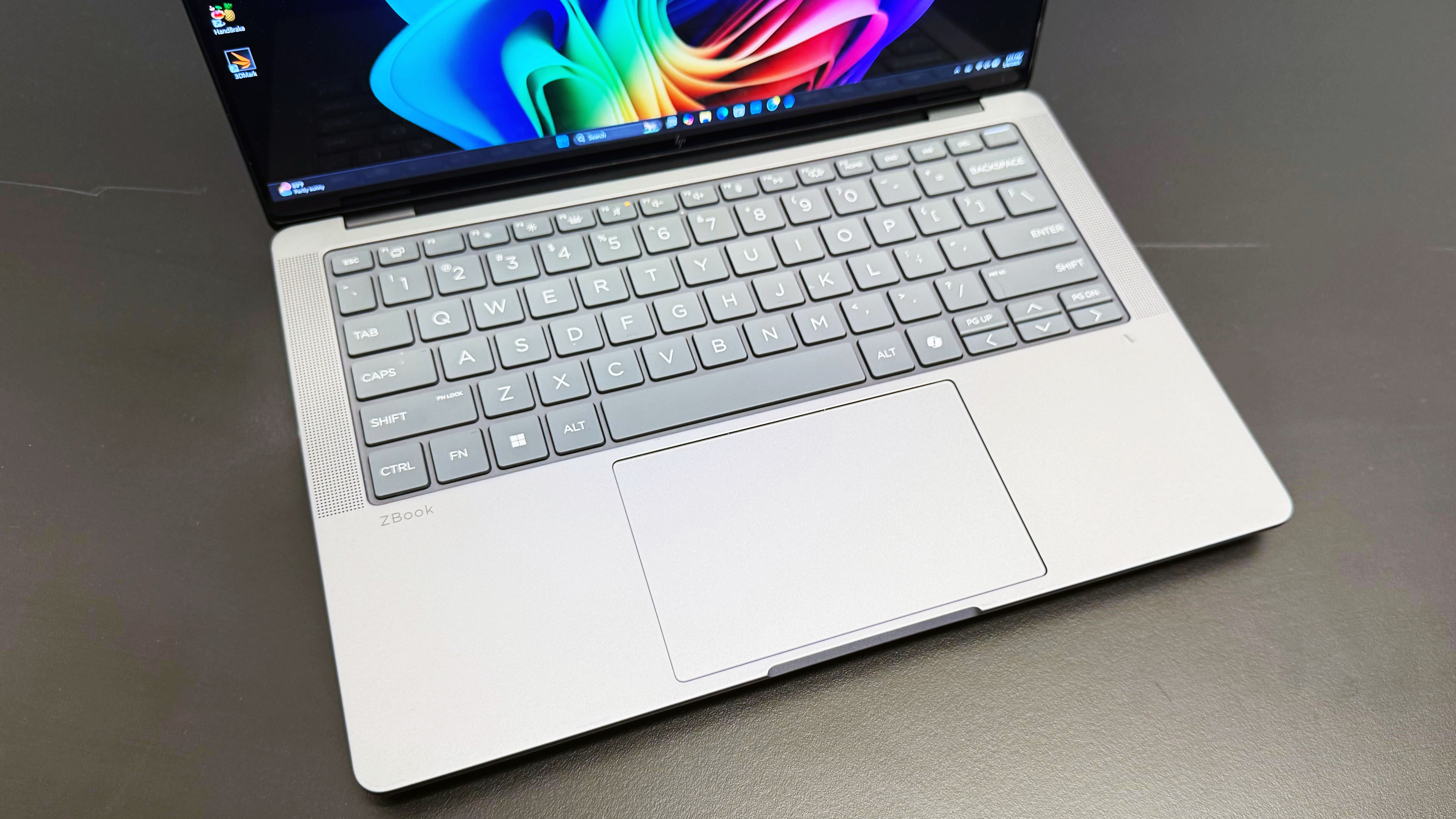 Top-angle shot of the keyboard on HP ZBook Ultra 14 G1a mobile workstation open on a black desk.