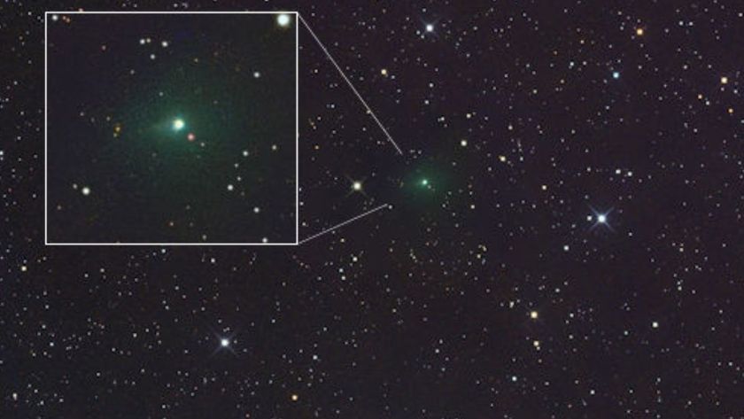 A glowing green light is seen in the center of a starry image from space but also in a white cutout box on the left part of the image