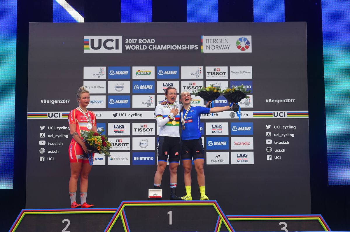 Elena Pirrone and Letizia Paternoster sing the anthem as Emma Cecilie Norsgaard Jorgensen (Denmark) watches on