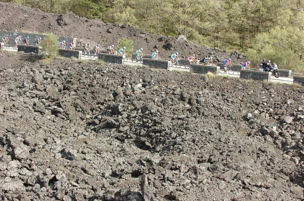 The Giro peloton rides through the volcanic rocks on Mount Etna in 2011