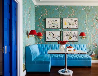 breakfast nook with floral wallpaper and blue banquette