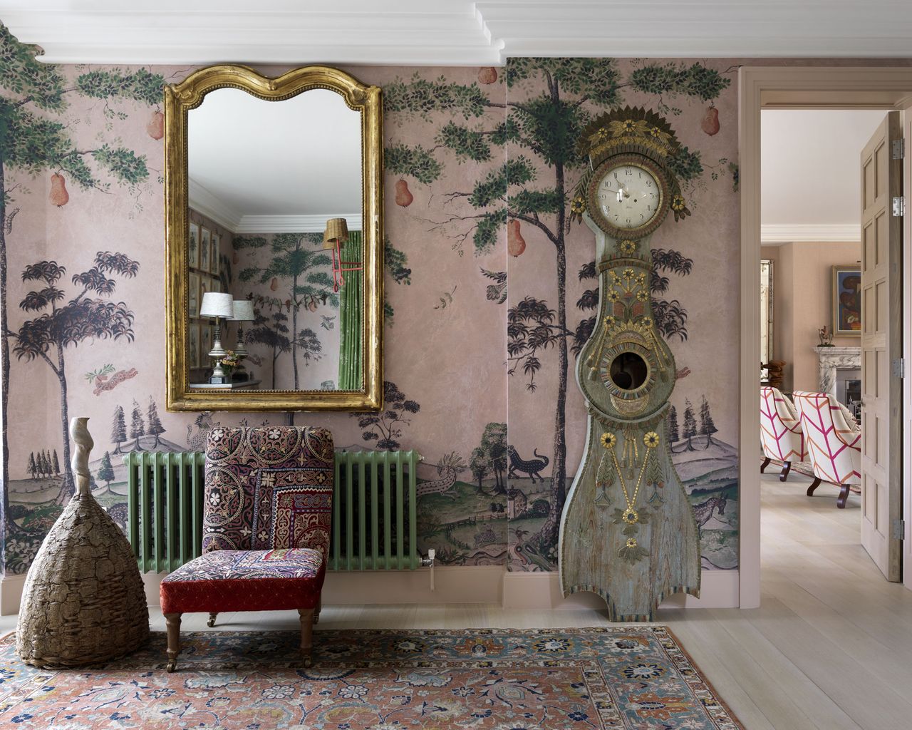 pink entrance hall with patterned wallpaper and Mora clock in Kit Kemp&#039;s London house