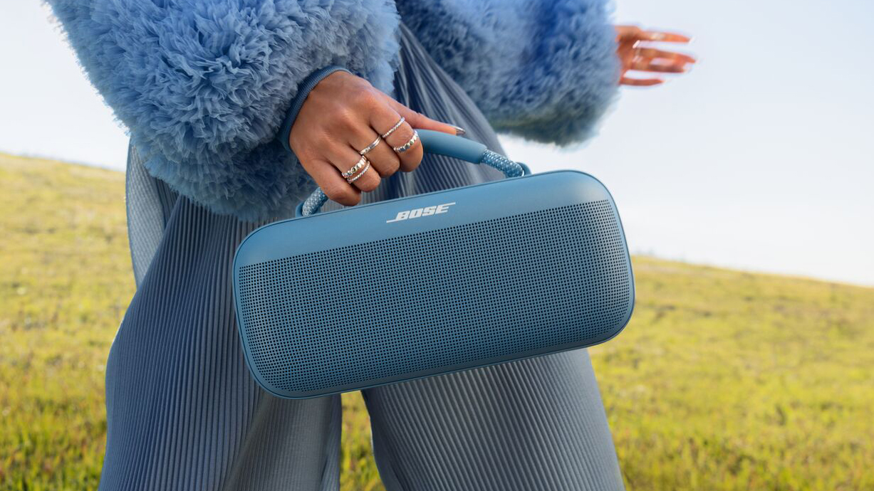 A woman holding the Bose SoundLink Max speaker