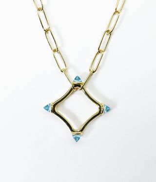 Gold chain necklace with a blue-tipped gold star hanging down