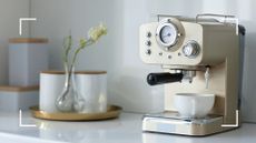  picture of a cream espresso machine in a neutral kitchen to support an expert guide on how to clean a coffee machine