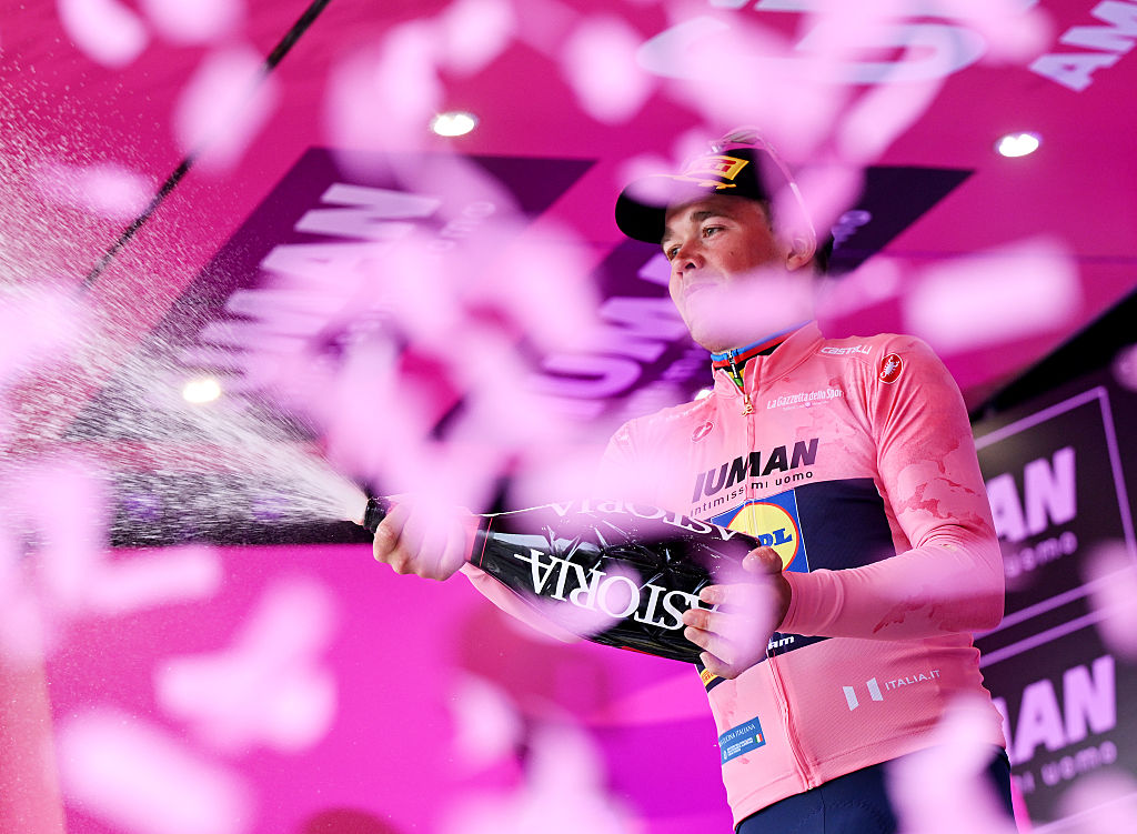 Mads Pedersen in pink jersey on podium