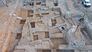 An aerial view of an excavation site containing a building with multiple rooms.