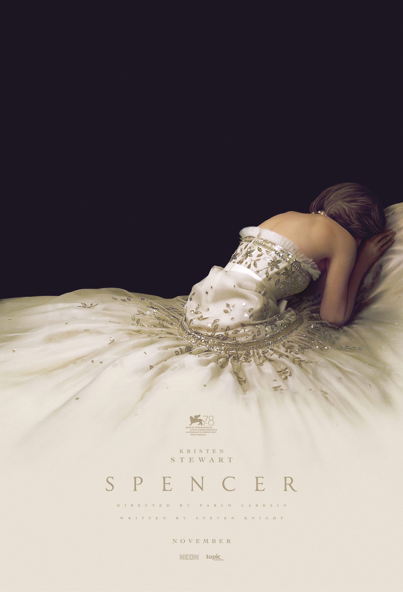 The movie poster for Spencer. The poster features a woman crying into a large cream dress.