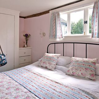 pink bedroom with bed and wardrobe