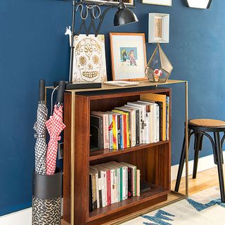 blue indigo wall book shelves wooden flooring and umbrella