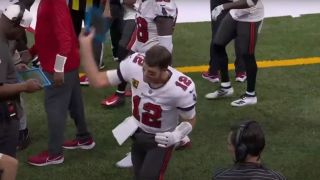 Tom Brady throwing a tablet
