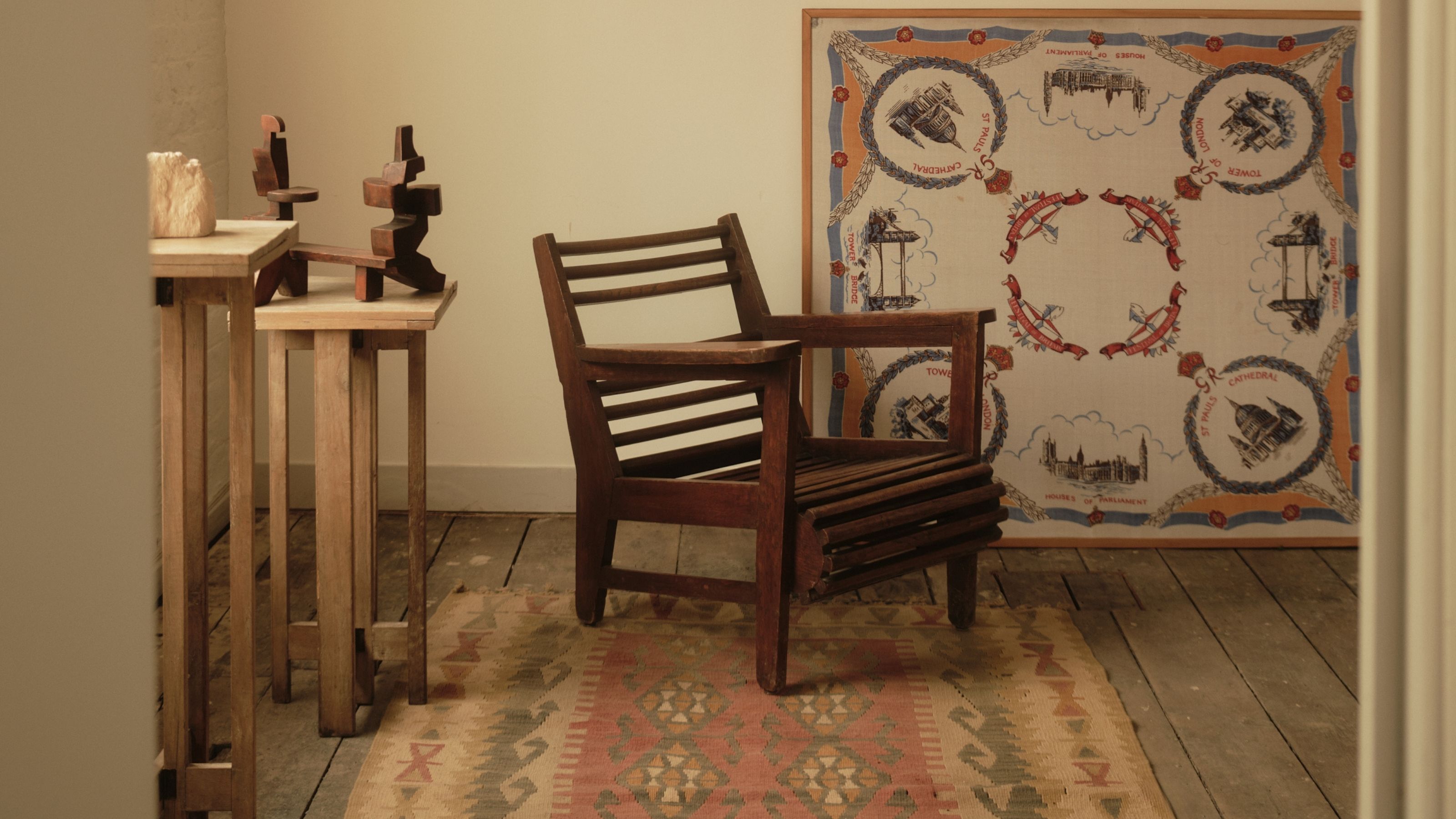 A former warehouse, now converted into a beautifully designed and decorated factory filled with mid-century modern and period wooden furniture, pops of colors, intricate fabrics, and lots of sunshine.