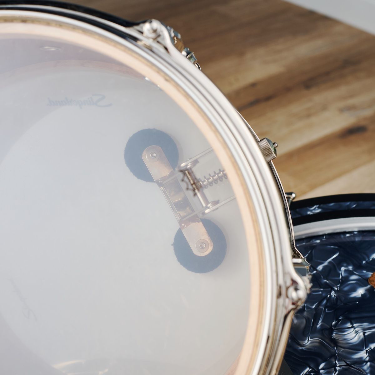 Slingerland Radio King snare drum damper seen through the resonant head