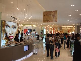 shoppers at L'Oreal cosmetics counter