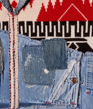 Close up view of wooly sweater with denim patches