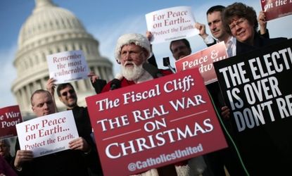 A man dressed as Santa Claus speaks outside the U.S. Capitol before making his way to House Speaker John Boehner's office on Dec. 12.