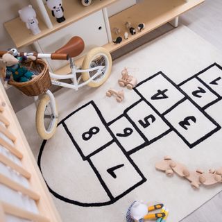 Rug showing hopscotch in child's bedroom by Bobby Rabbit