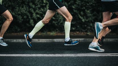 Benefits of compression socks for running: Pictured here, a group of runners running on a road