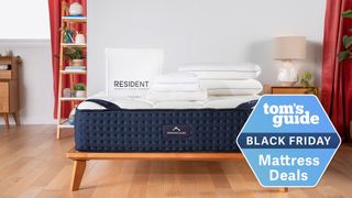 The DreamCloud Luxury Hybrid shown on a wooden bed frame with a Black Friday mattress deals badge overlaid