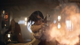 Kora ducks as she fires her gun in Rebel Moon Part 1: A Child of Fire