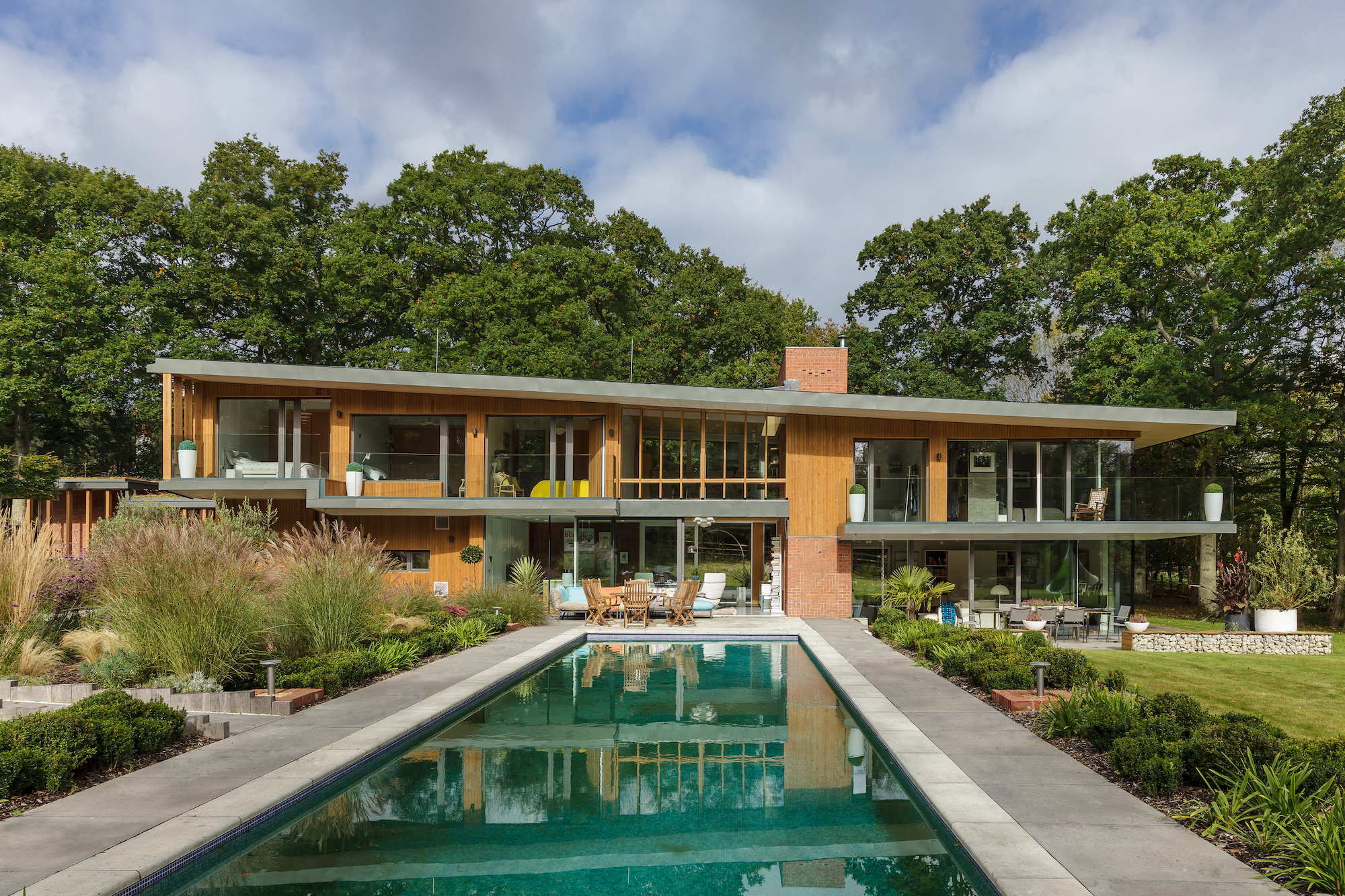 large natural swimming pool in garden outside modern self build