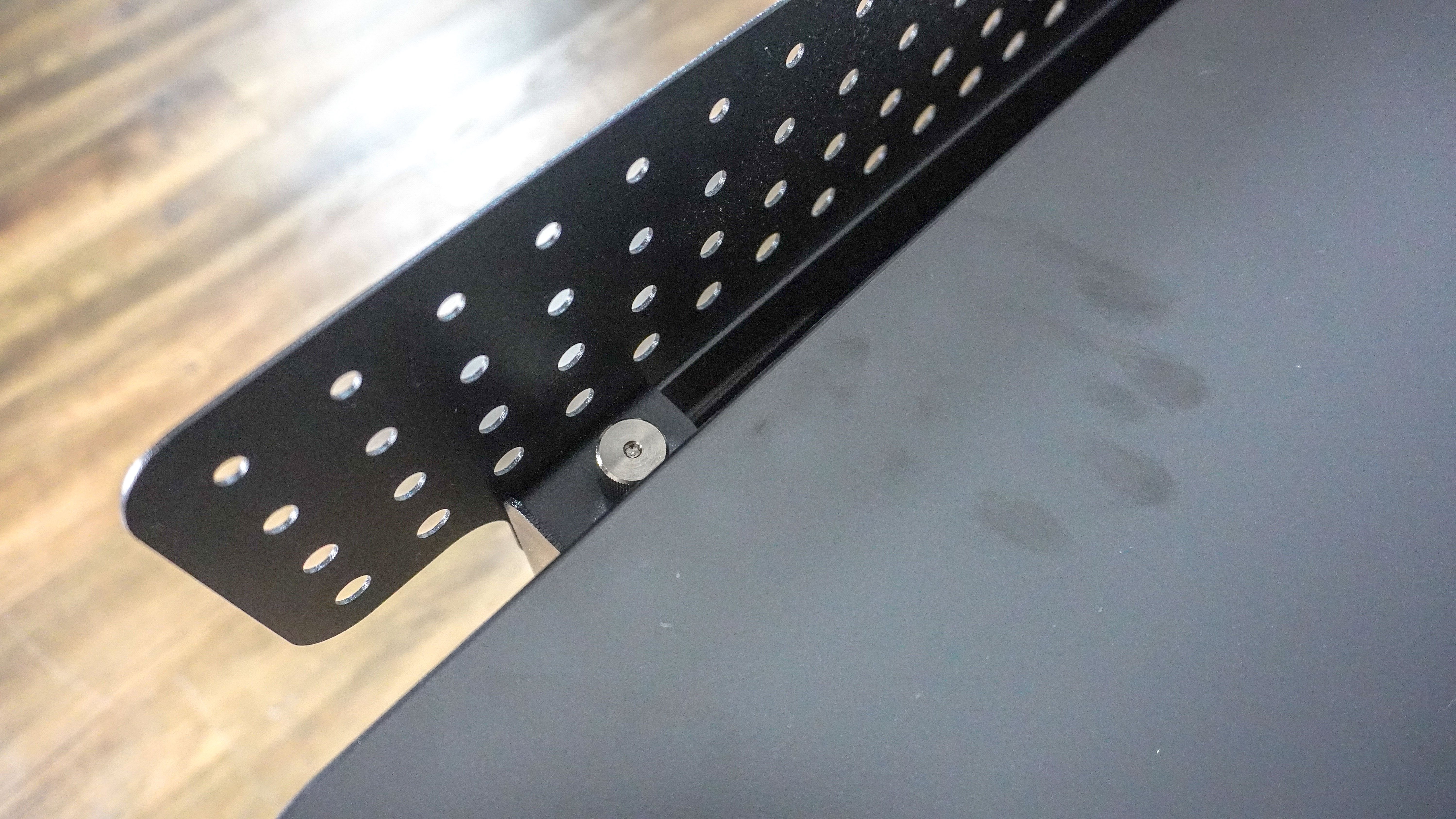An overhead shot showing the bolts you have to hand-tighten to install the optional shroud on the Herman Miller Coyl Gaming Desk