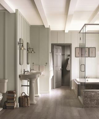 Green gray bathroom with white ceiling, hardwood floor, shower to the right,