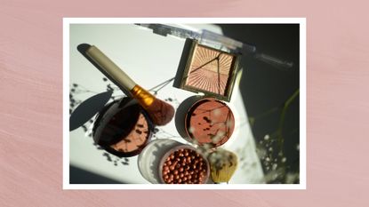 A close up of a collection of bronzer and shimmery makeup products arranged on an aesthetic backdrop, with silhouettes and flowers/ in a pink textured template