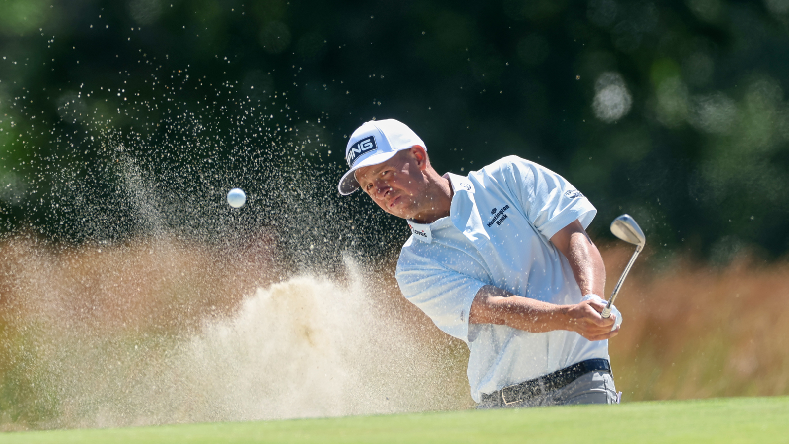 Sam Stevens hits a bunker shot