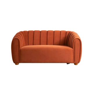 A rust colored small sofa